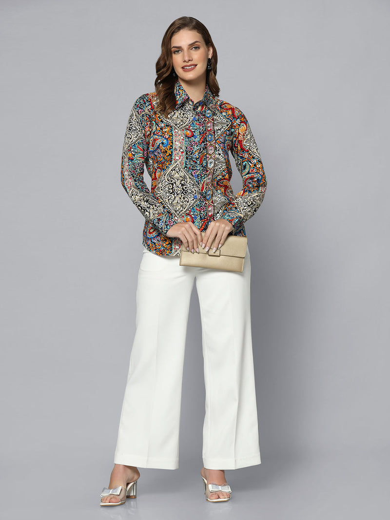 Multicolor rayon collared shirt styled with elegant white trousers.