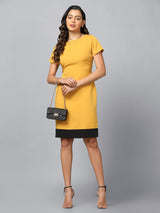 Mustard stretch sheath dress with black hemline, perfect for evening wear.