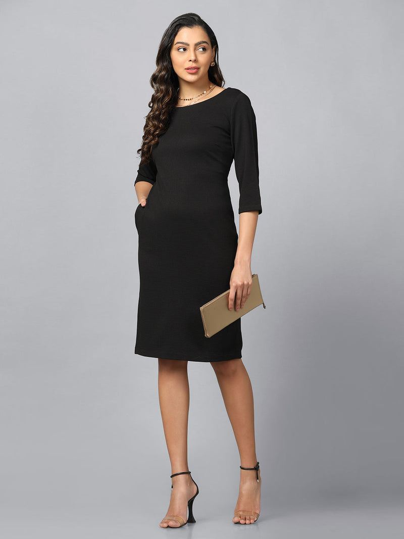 Black stretch knit shift dress with pockets, elegant women's fashion.