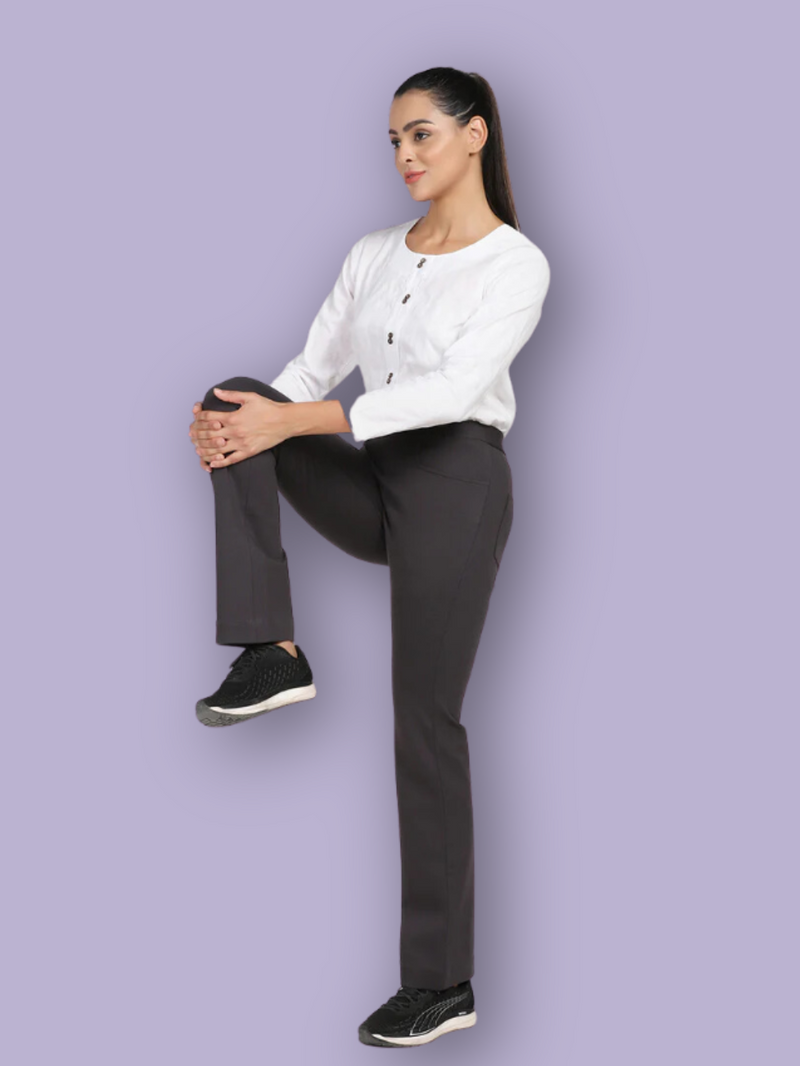 Stylish woman wearing boot cut mid waist stretch pants in black.