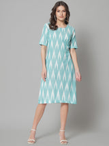 Ikat print cotton dress in green, featuring a stylish design.