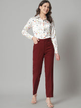 Printed collared shirt in white with colorful pattern, stylish outfit choice.