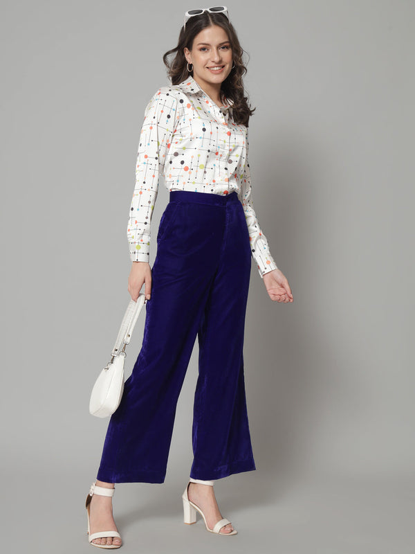 Comfortable blue velvet trousers styled for a chic look.