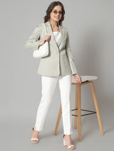 Notched collar blazer in sage green, styled with white pants.