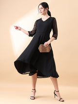 Straight fit A-line flared black dress with sheer sleeves and elegant design.