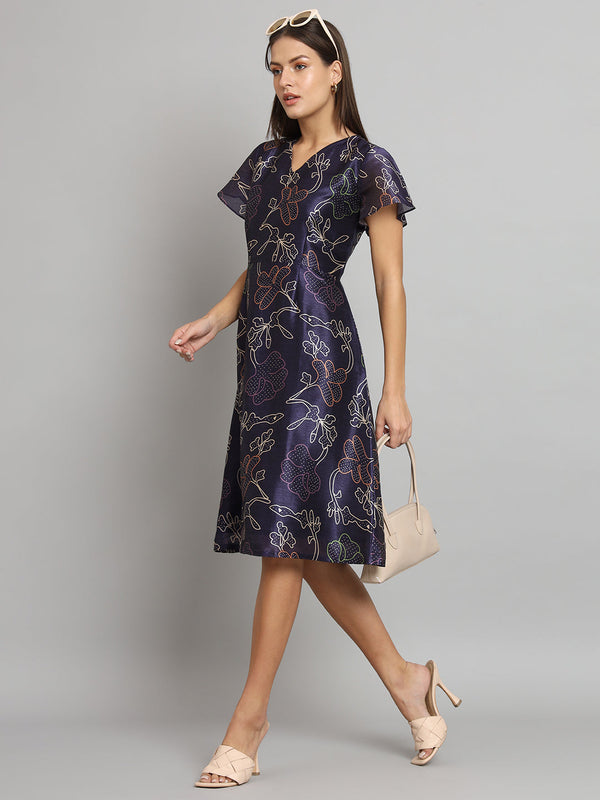 Printed silk A-line dress in blue with floral design.