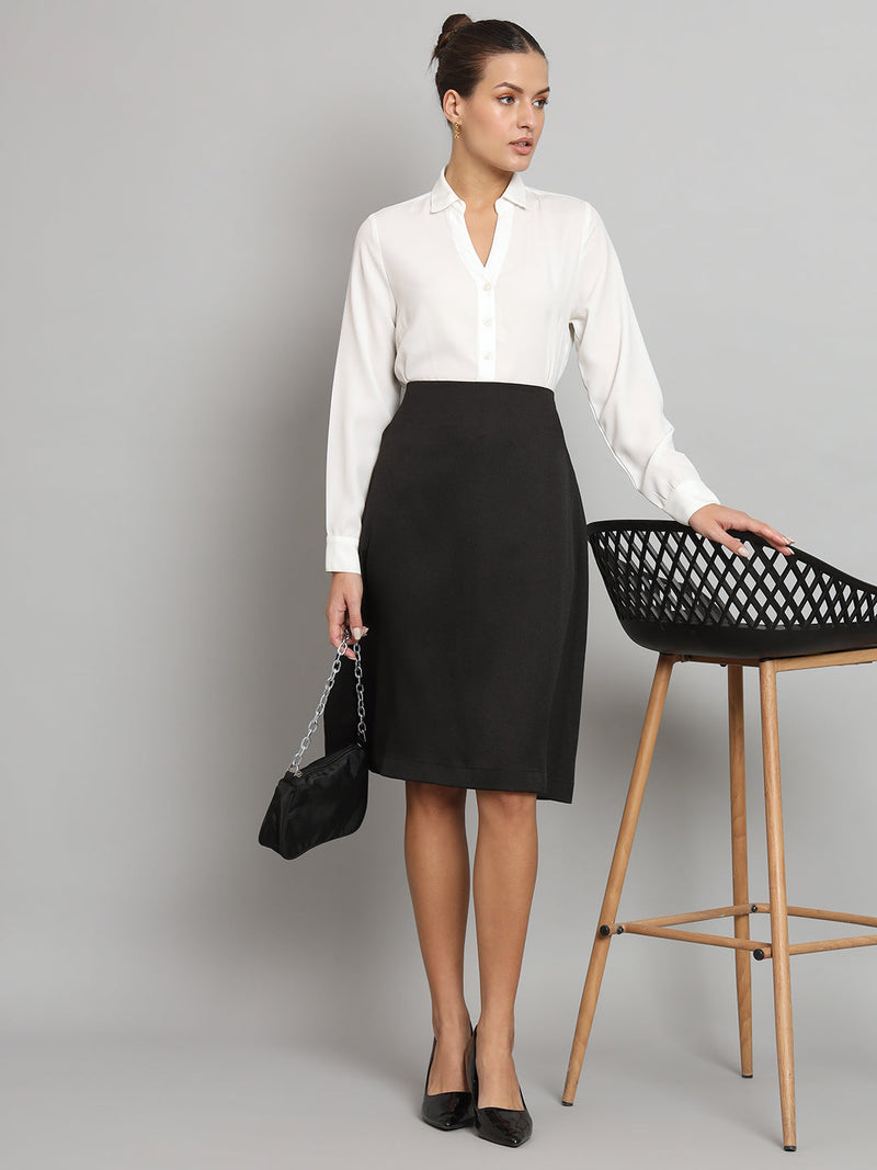 A-Line Moss Skirt in Black styled with white blouse and handbag.