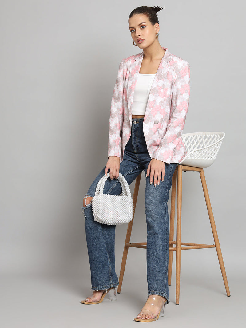 Printed pink notch collar blazer styled with casual jeans and accessories.