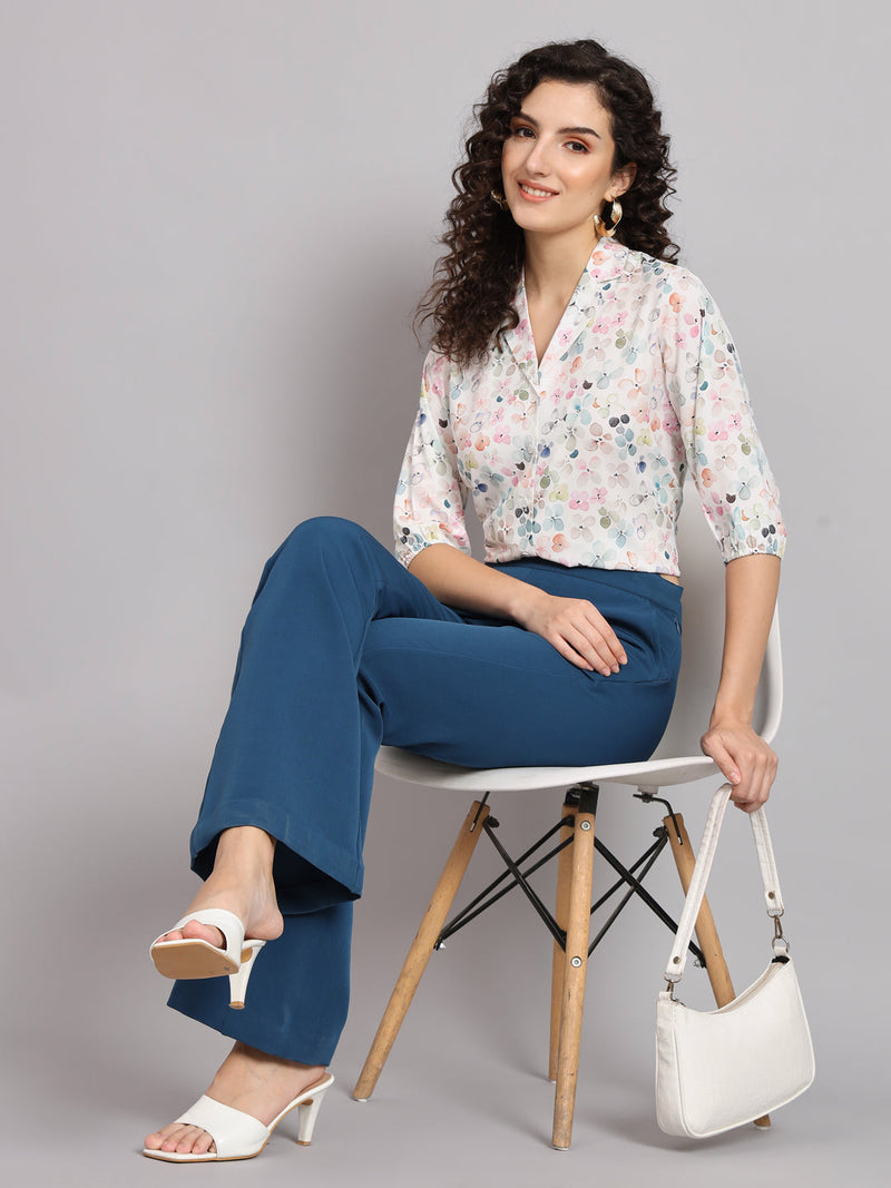 Floral printed white shirt styled with chic pants and accessories.