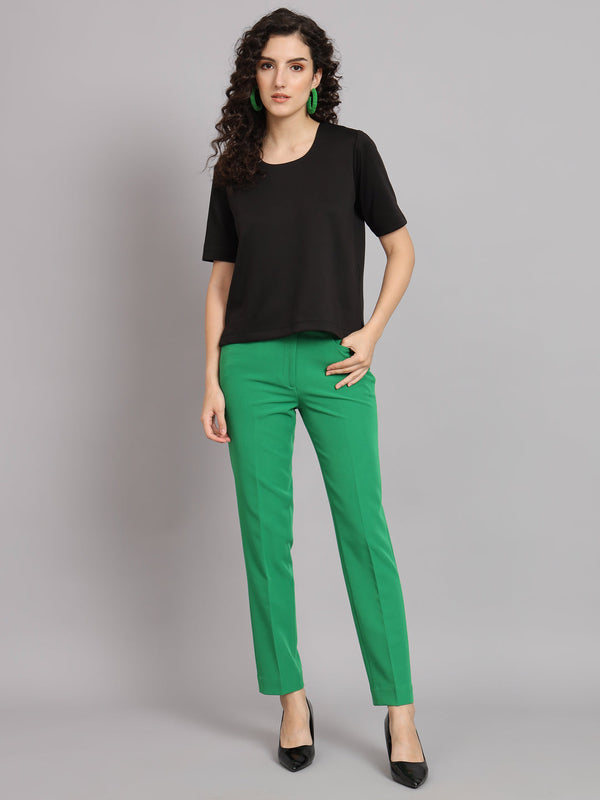 Comfort Fit Round Neck Top in black, paired with green trousers.