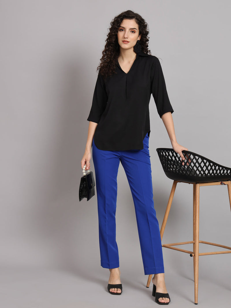 V-Neck black shirt with box pleat styled with blue pants.