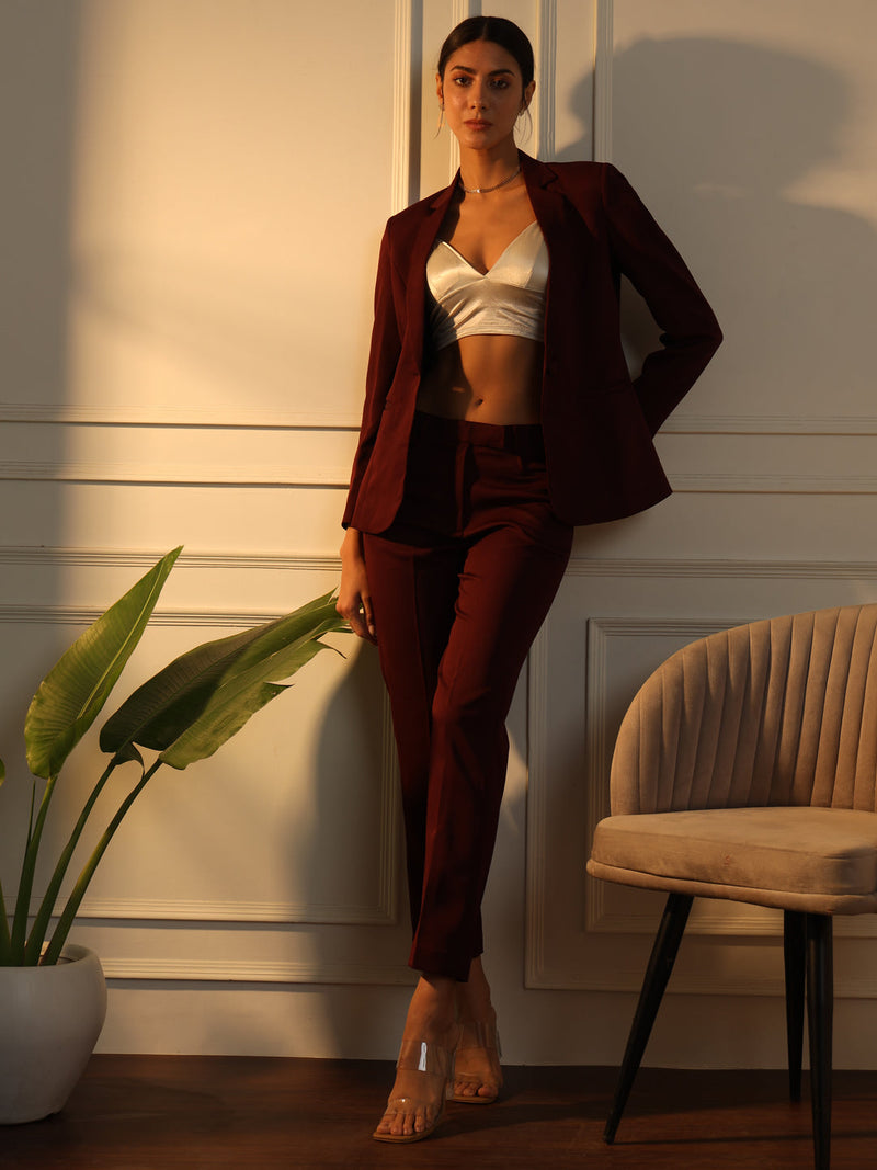 Notched collar stretch pant suit in maroon, styled elegantly for women.