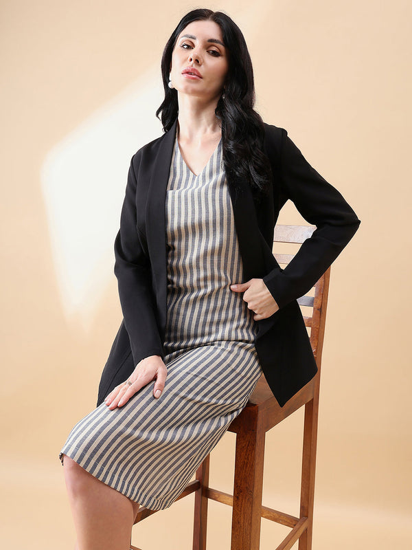 Open front shawl lapel blazer in black, styled with striped dress.