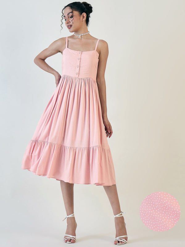 Pink dotted strappy fit and flare dress with a flared hem.