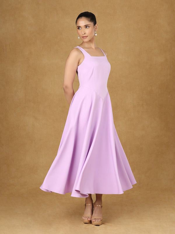 Lavender strappy fit and flare dress displayed on model.