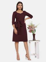 Jewel neckline A-line evening dress in wine color with floral arrangement.