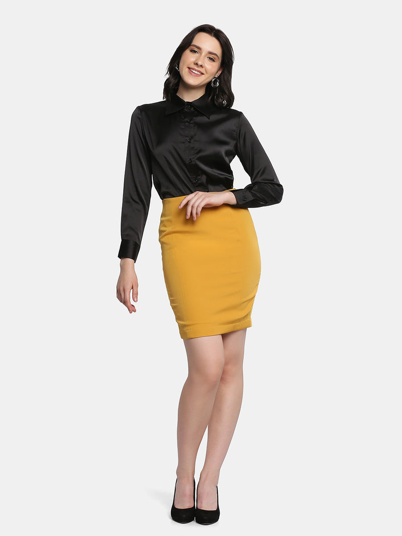 Stylish woman modeling a mustard yellow stretch pencil skirt.