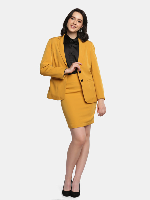 Business formal yellow skirt suit with black blouse and heels.