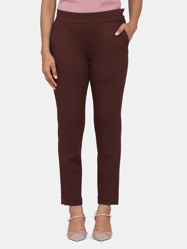 Slim-fit stretch trousers for women in chocolate brown color.