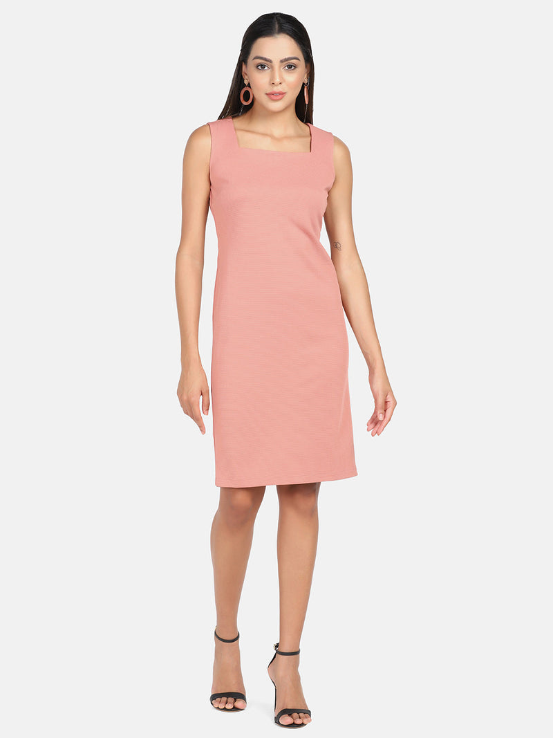 Stretch sleeveless sheath dress in peach, perfect for summer occasions.