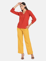 Mid waist pleated wide bottom pants showcased with a stylish top.