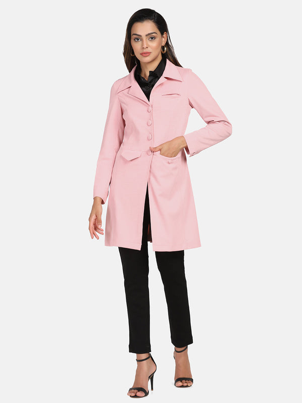 Longline stretch jacket in pink, styled with black pants and heels.