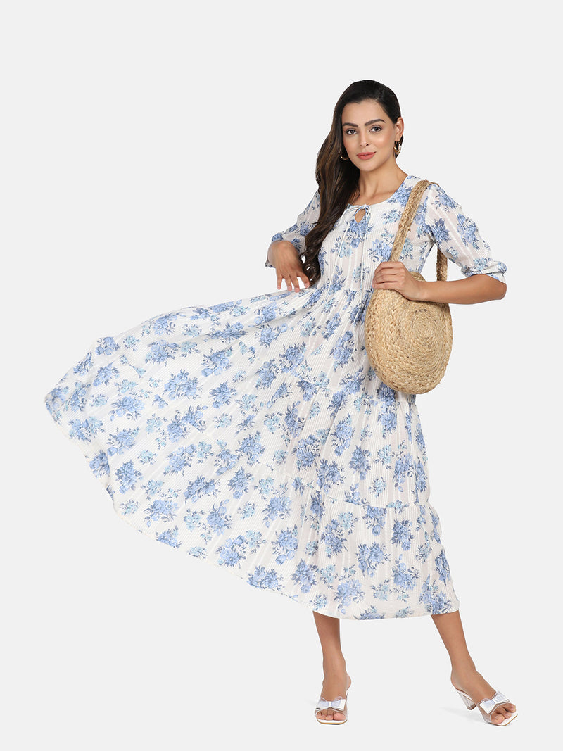 Cotton tier dress in blue and white floral design on model.