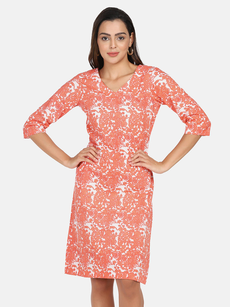 Cotton printed A-line dress in orange and white floral design.