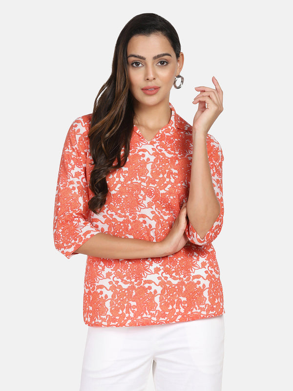 Printed cotton top in orange and white floral pattern.