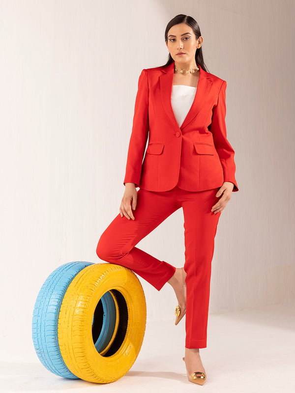 Women's red formal stretch pant suit displayed with colorful tires.