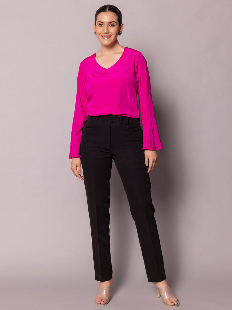 Regular fit hot pink bell sleeves crepe top styled with black pants.