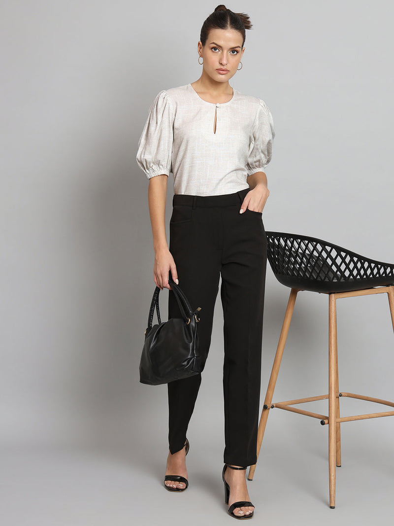 Balloon sleeves light beige viscose linen top styled with black trousers.