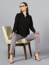 Slim fit mid waist stretch pants in grey, styled with a black shirt.