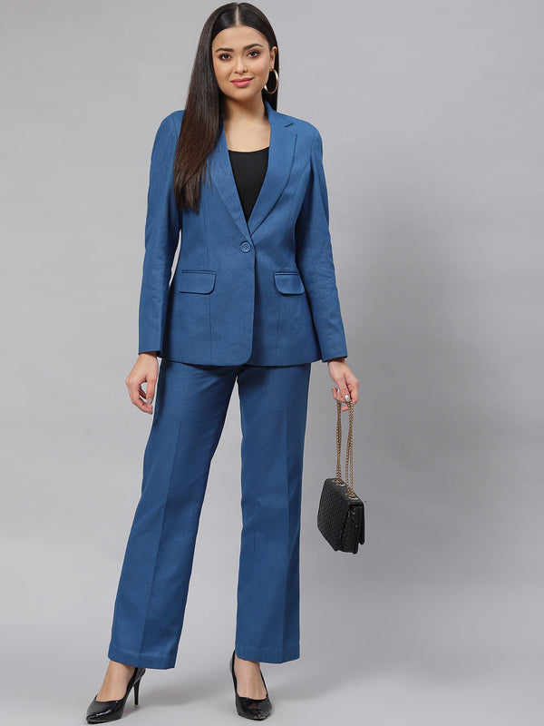 Warm teal blue tweed pantsuit with stylish heels and handbag.